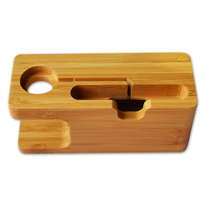 Bamboo phone and watch stand charging station on a desk