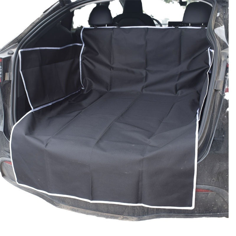 Dog sitting on a black cargo liner in an SUV trunk - view 6