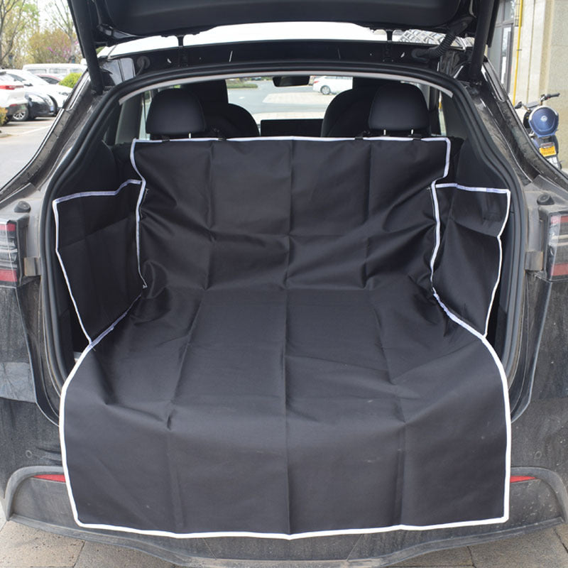 Dog sitting on a black cargo liner in an SUV trunk - view 9