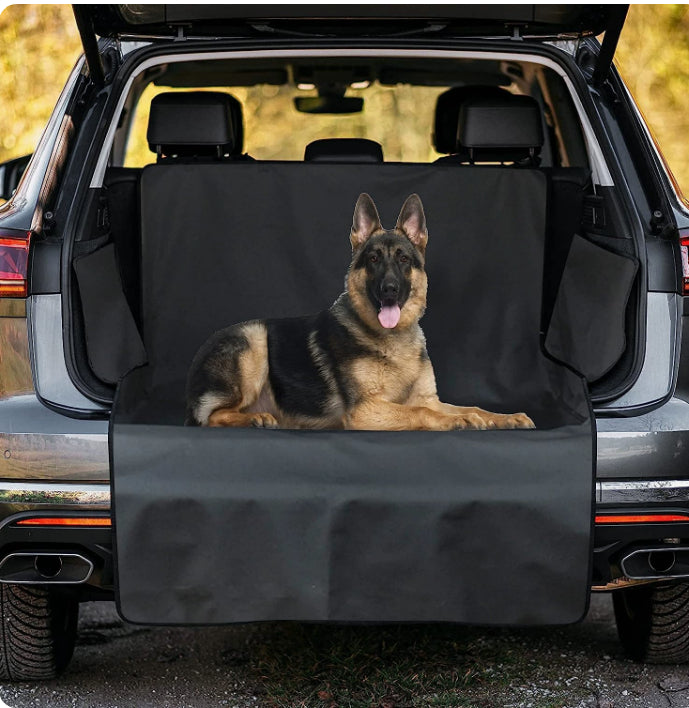 Dog sitting on a black cargo liner in an SUV trunk - view 11