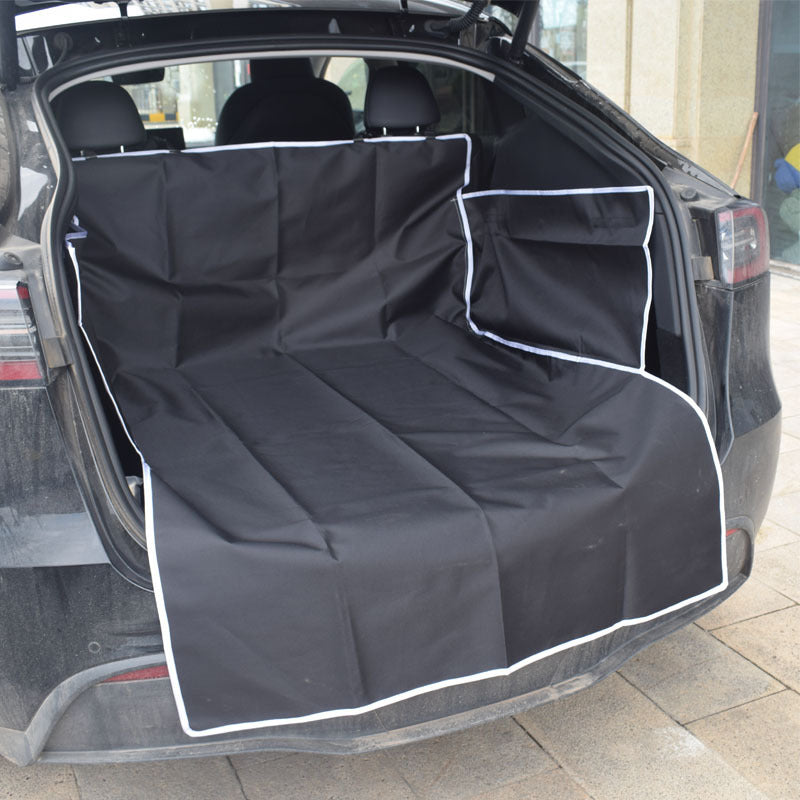 Dog sitting on a black cargo liner in an SUV trunk - view 8