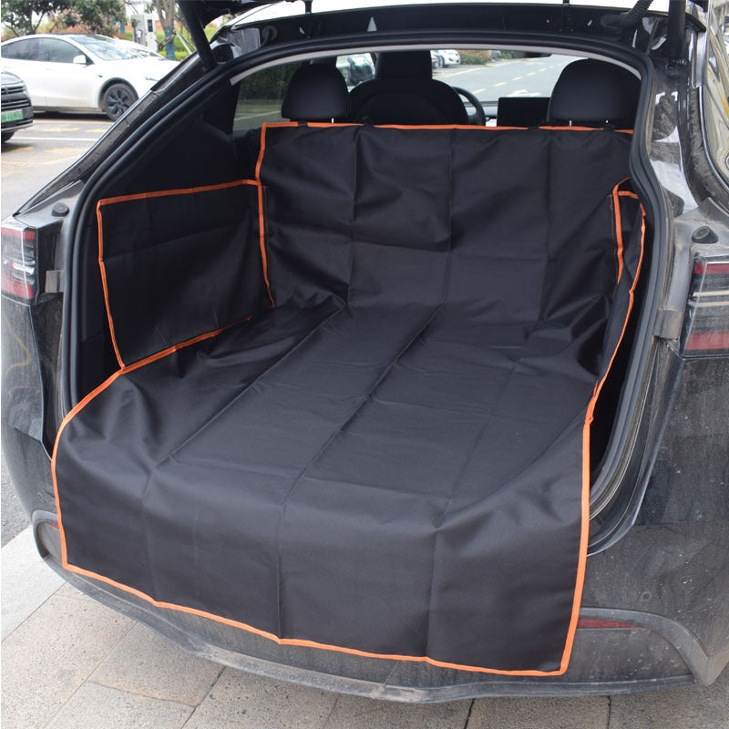 Dog sitting on a black cargo liner in an SUV trunk - view 3